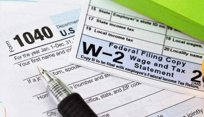 A picture of W2 tax form with a pen.