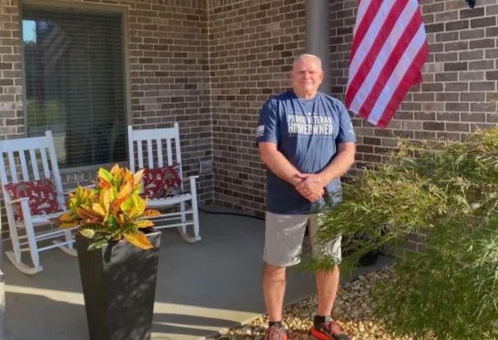 picture of Donald J. in front of a house
